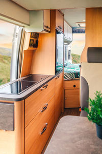 Interior of a camper van with kitchen and bed