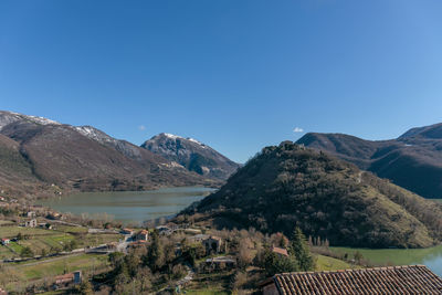 Scenic view of mountains against clear blue sky