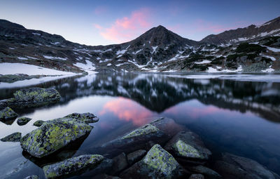 Scenic view of lake and snowcapped mountains against sky