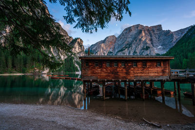 Gazebo by lake against mountains