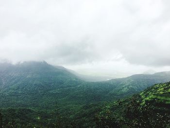 Scenic view of tree mountains against cloudy sky