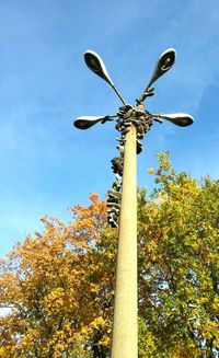 Low angle view of street light against blue sky