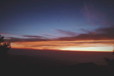 Scenic view of silhouette mountains against sky during sunset