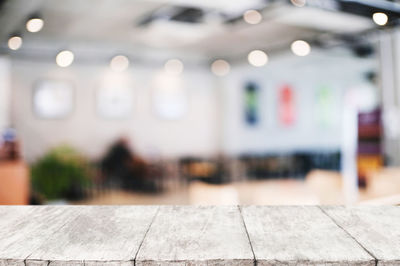 Defocused image of illuminated lights on table at restaurant