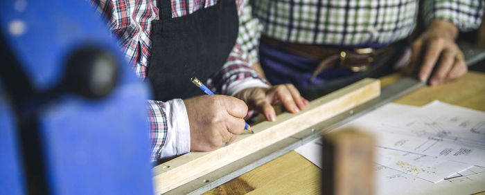 Midsection of man working on paper