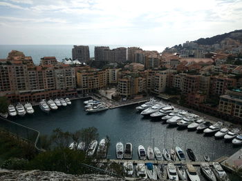 High angle view of cityscape by sea against sky