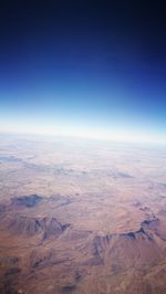 Aerial view of landscape against blue sky