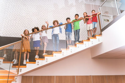 Low angle view of kids standing on staircase