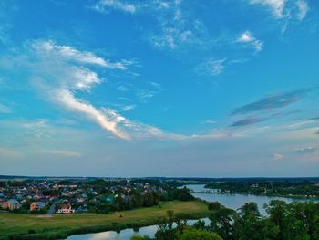 Scenic view of sea and townscape against sky