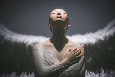 Woman looking away against white background