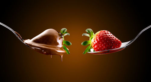 Close-up of strawberry over black background