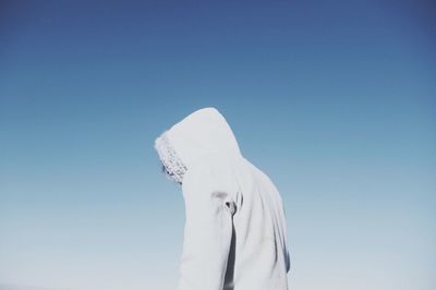 Low angle view of white wall against clear blue sky