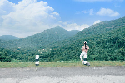 Full length of man standing on mountain against sky