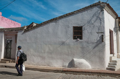 Rear view of man walking outside building