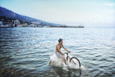 Walking by the sea on a bicycle