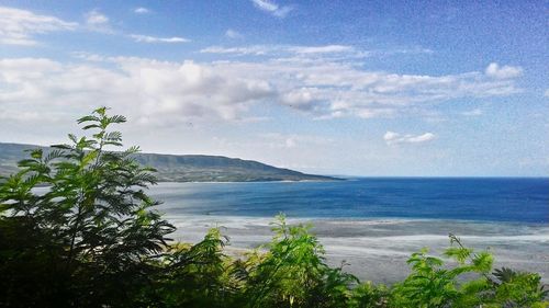 Scenic view of sea against cloudy sky