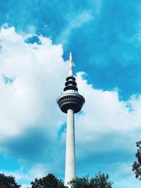 Low angle view of communications tower against sky