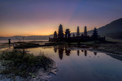 Scenic view of building against sky during sunset