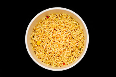 High angle view of soup in bowl against black background