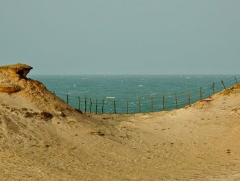 Scenic view of beach against clear sky