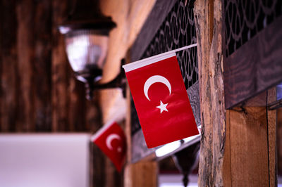 Close-up of red heart shape hanging on wood