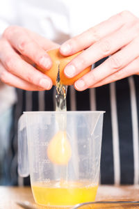 Close-up of cropped hand holding glass