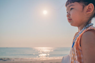 Portrait of man on beach against sky during sunset
