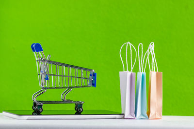 Close-up of shopping cart against wall in store