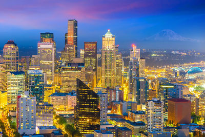 Aerial view of illuminated buildings in city at night