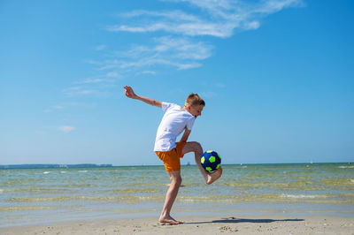 Full length of man on beach against sky