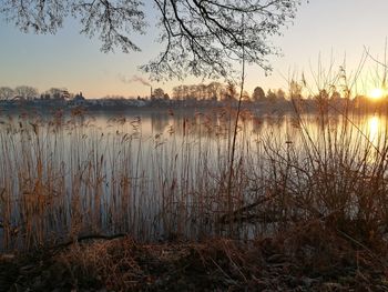 Scenic view of lake against sky during sunset