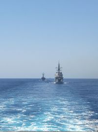 Ship sailing in sea against clear sky