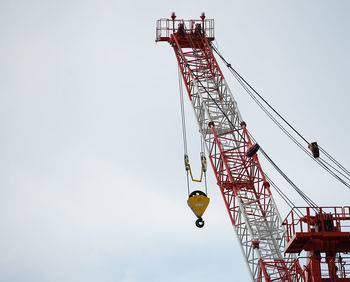 Low angle view of crane against clear sky