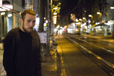 Rear view of man at railroad station at night