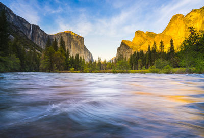 Scenic view of river amidst mountains against sky