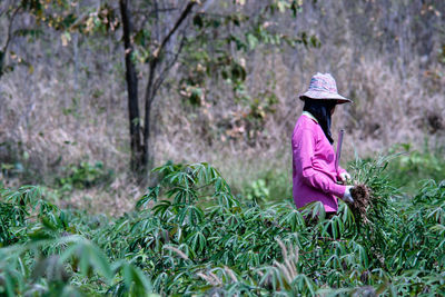 Portrait of woman standing amidst plants