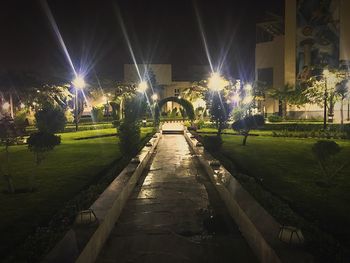 Illuminated city against sky at night