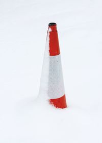 Close-up of snow covered traffic cone