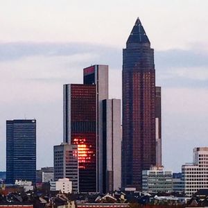 Buildings against cloudy sky