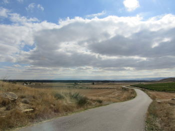 Empty road along countryside landscape