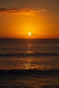 Scenic view of sea against orange sky