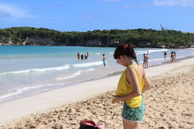 People on beach against sky