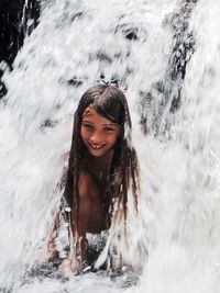 Portrait of a smiling young woman in water