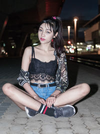 Portrait of young woman sitting outdoors