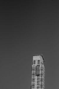 Low angle view of building against clear sky at night