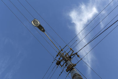 Low angle view of electricity pylon against sky