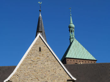 Low angle view of buildings against blue sky