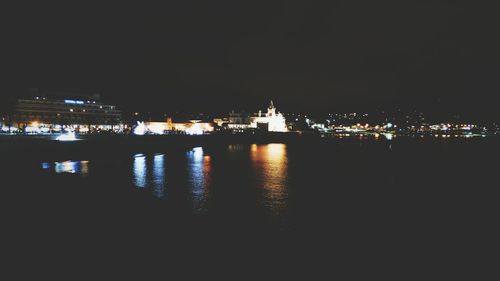 Illuminated city at waterfront