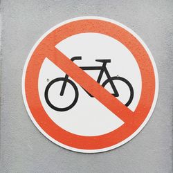 Close-up of no cycling sign mounted on wall