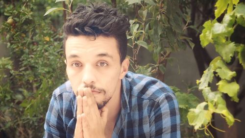 Portrait of young man holding food outdoors